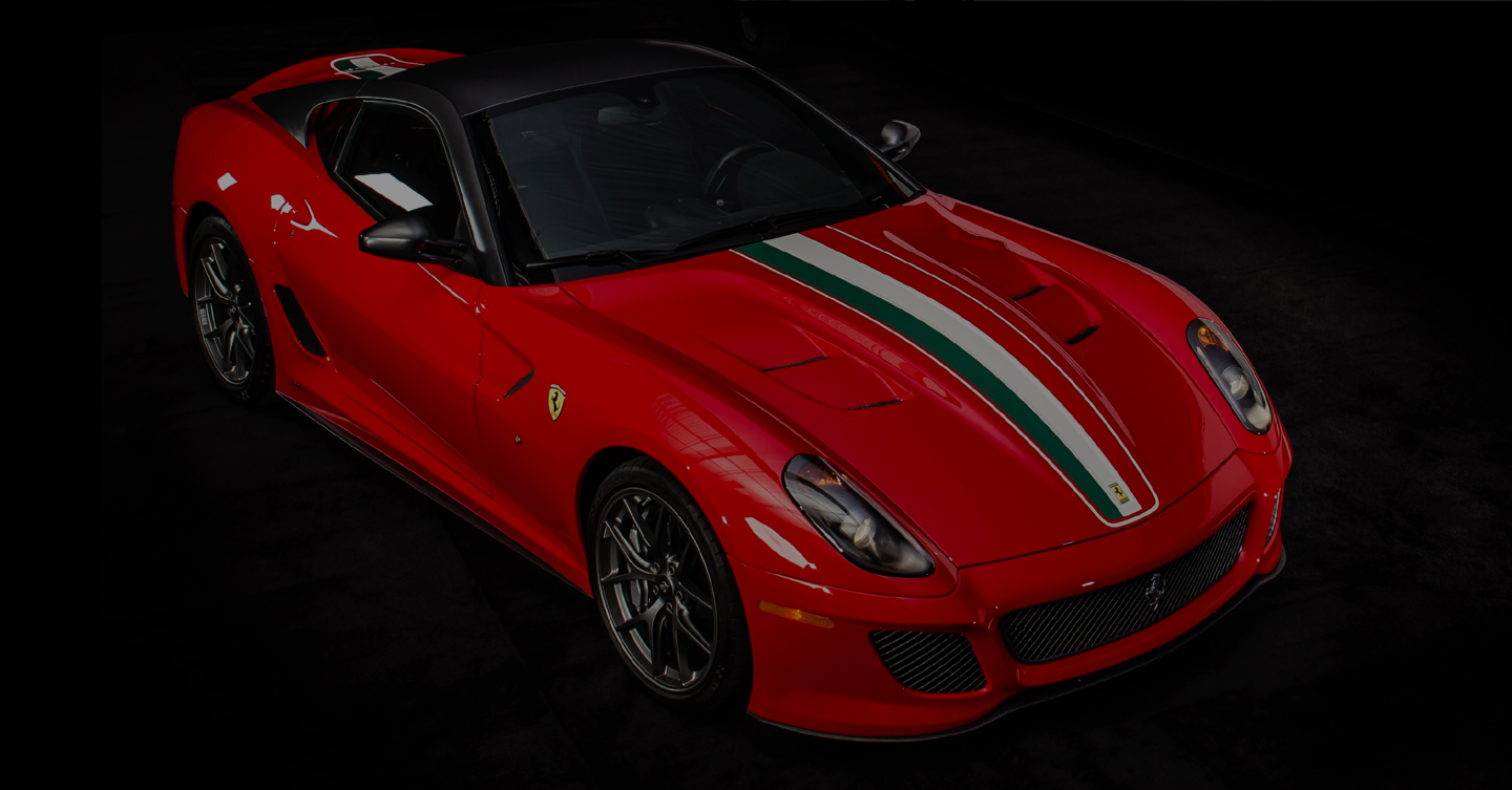 Ferrari {insert model}. Faded car background, closeup to the iconic red Ferrari keys.